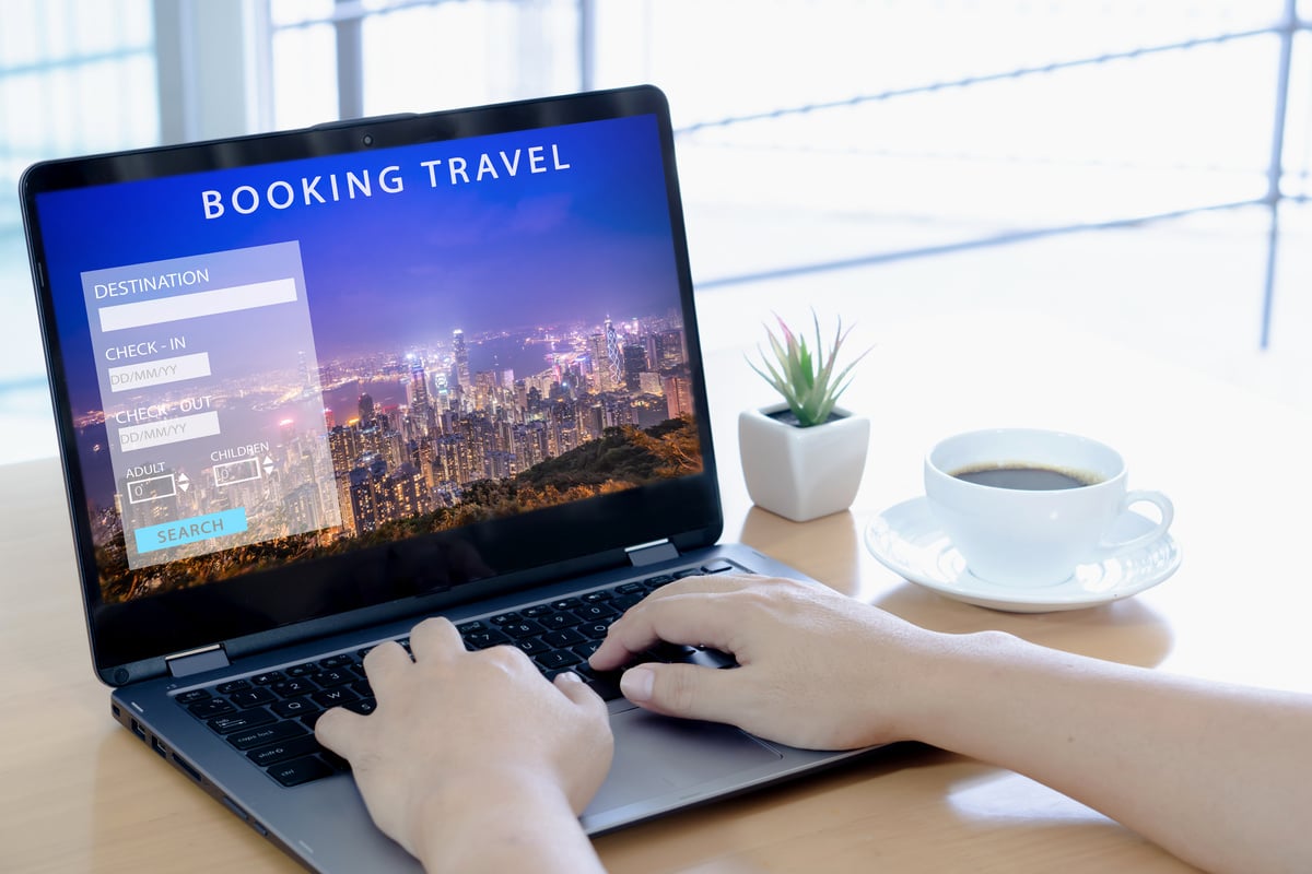 Man using a laptop for booking hotel online. Tour reservation